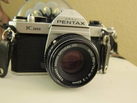 This is an image of Pentax K1000 Manual Focus SLR Film Camera with Pentax 50mm Lens