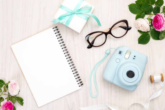 this is an image of a polaroid instant camera on a desk