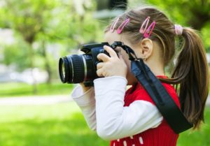 this is an image of a girl holding a camera