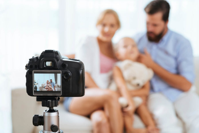 family using a Nikon camera to take a family portrait