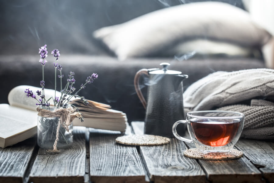 Picture of a teacup, a book and flowers on a table