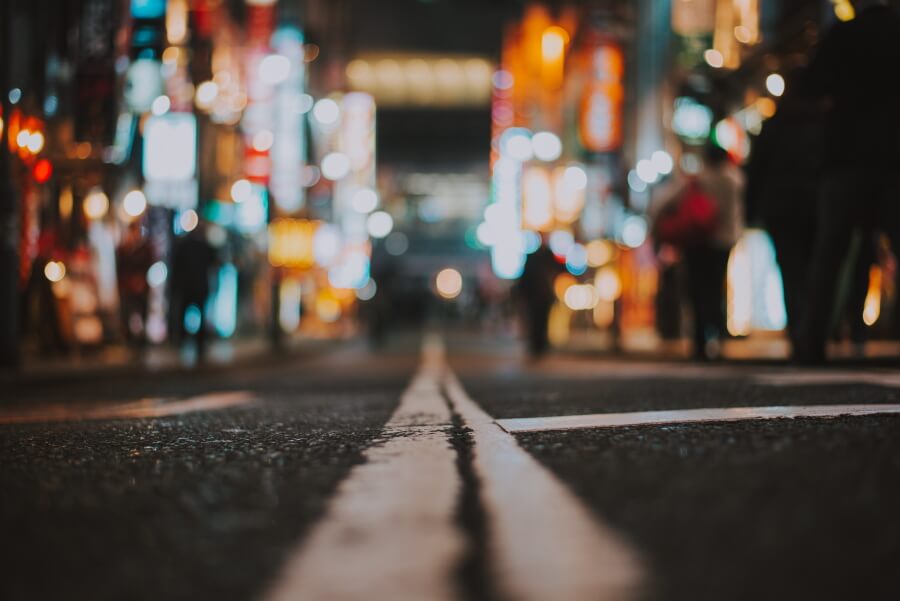 Photo at night of a street with blurred city lights
