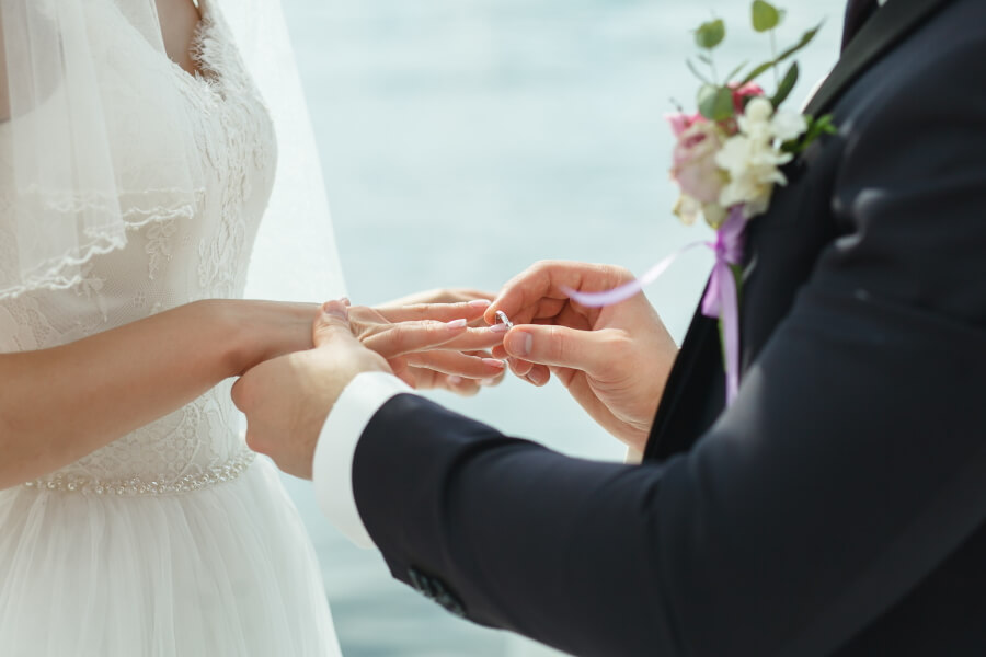 Photo of a bride receiving the ring from the groom